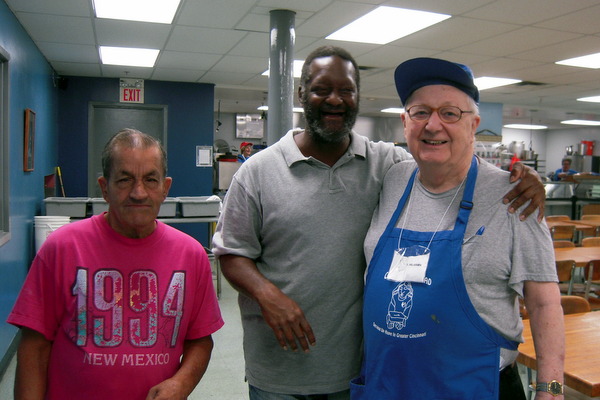 Fr. Hilarion with guests at Our Daily Bread