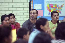 Immigrants hear a presentation by Sr. Norma Pimentel