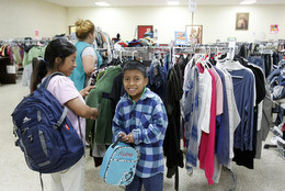 A volunteer helps a family find the right sizes.