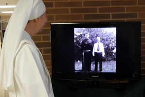 A Little Sister watches the slide show