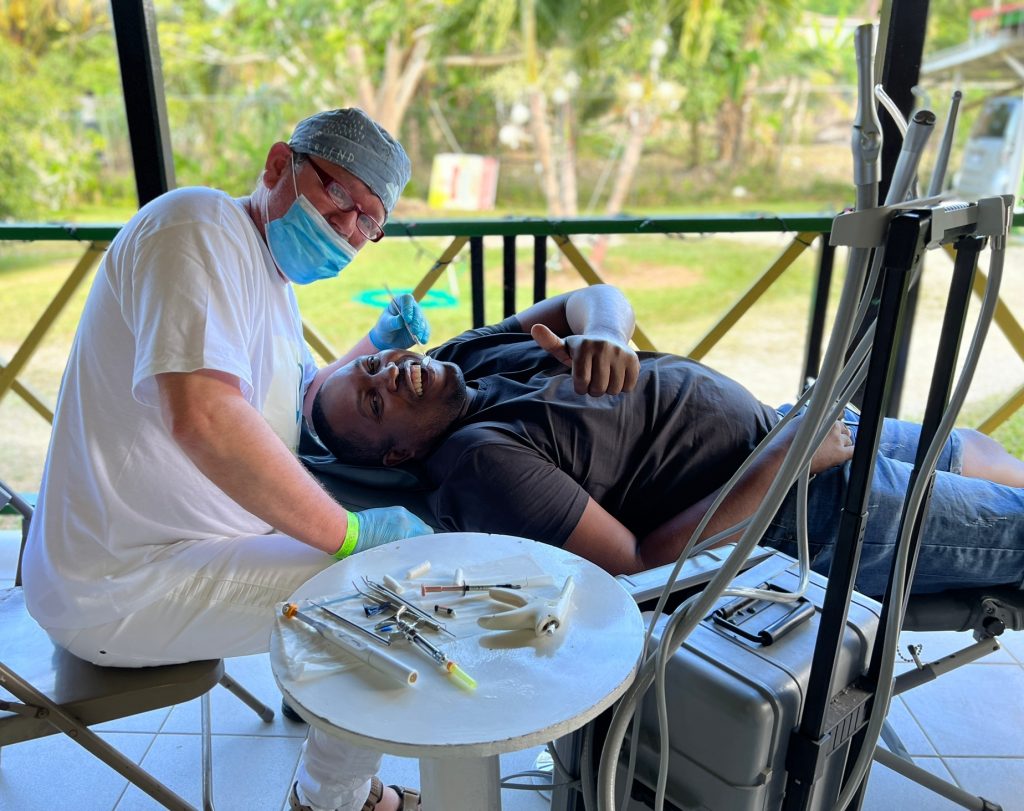 dentist and patient smiling in chair