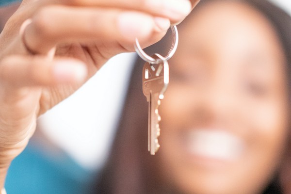 woman holding up key