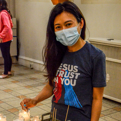 young woman lighting candle