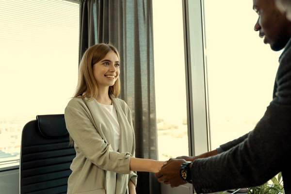 woman and man shaking hands