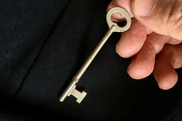 man pulling key out of pocket