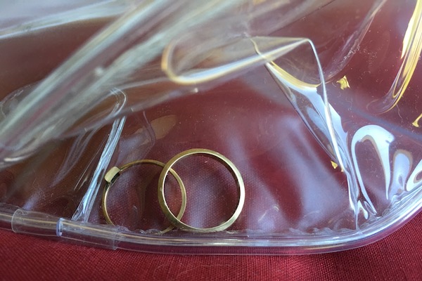 wedding rings in clear plastic purse