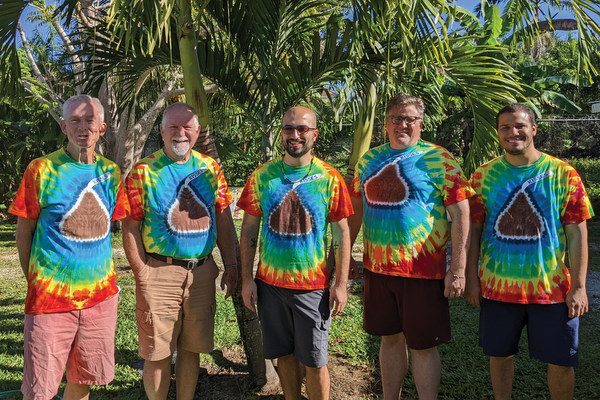 5 friars in bright t-shirts.