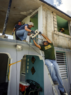 men handling concrete blocks