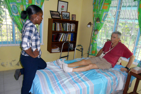 Physical therapist Ms. Addiman assesses Fr. Jim's situation.