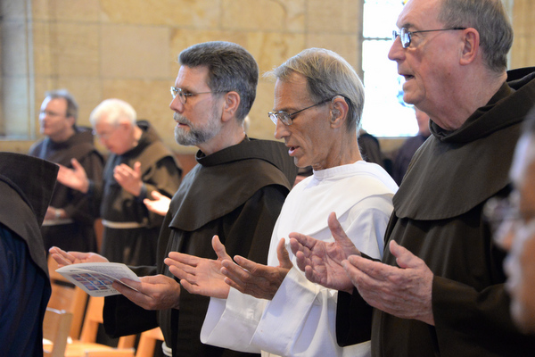 Friars praying in church