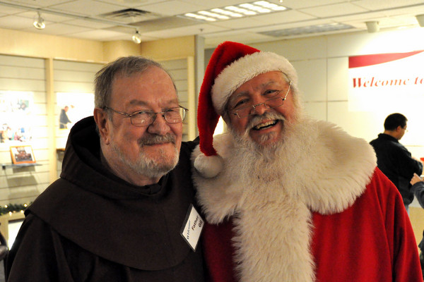 Fr. Gil Wohler, OFM, with Santa Claus at Northgate Mall during 'Advent with the Franciscans'