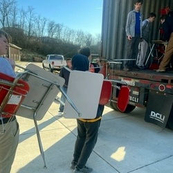 students carrying desks