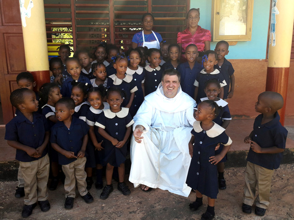 friar with school children