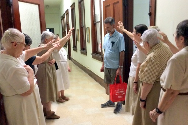 Br. Mark Gehret, OFM, receives a blessing from the New Orleans Poor Clares