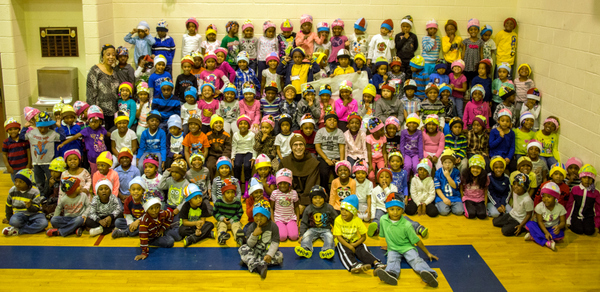 Br. Al Mascia, OFM, surrounded by students at Crescent Academy