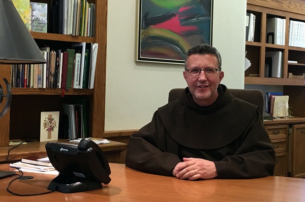 Fr. Mark Soehner at desk