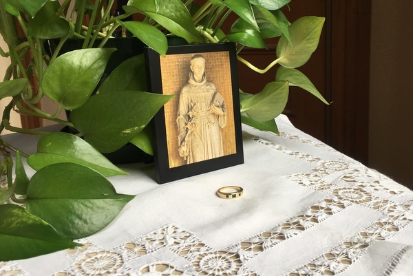 St. Anthony image and ring on table