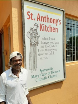 man and St. Anthony sign