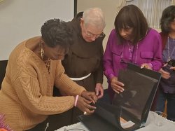 3 people look at scrap book