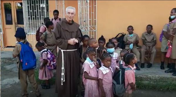 Fr. Jim Bok, OFM, with Jamaican schoolchildren