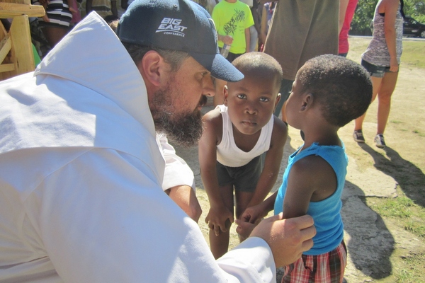 friar with children in Jamaica