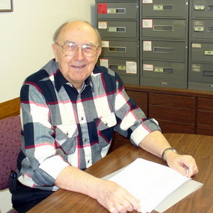 Fr. Bruno at a desk