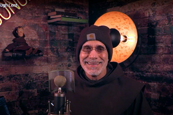 friar with microphone