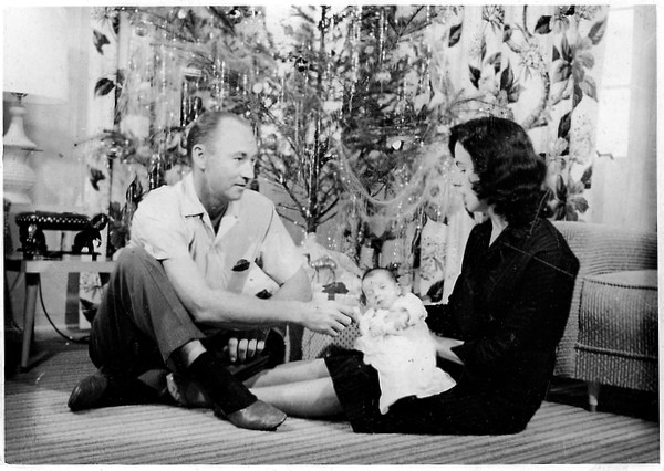 Baby Miriam with parents in front of Christmas tree