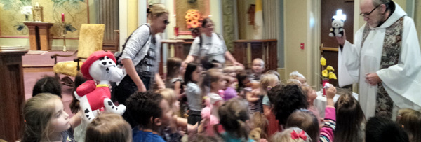 Fr. David Moczulski, OFM, blesses stuffed animals at Sisters of Charity chapel.