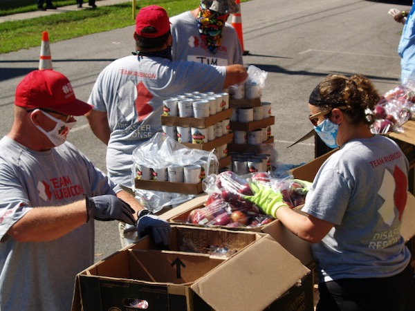 Volunteers pack food boxes