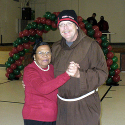 Fr. Dennis Bosse dances with parishioner