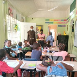 friar and teacher with students in class