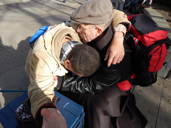 Br. Michael Radomski comforting a man in despair.