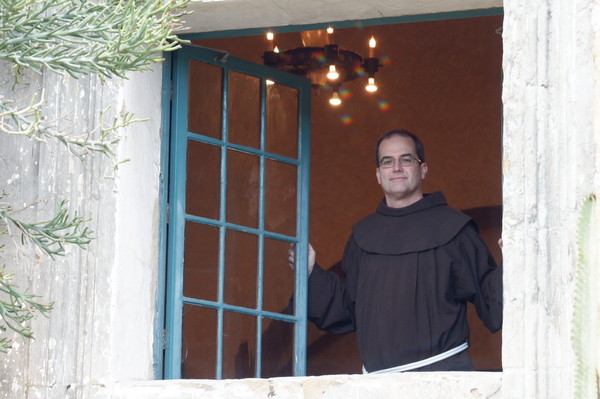 Br. Matt Ryan looks out a window at the Franciscan International Novitiate in Santa Barbara