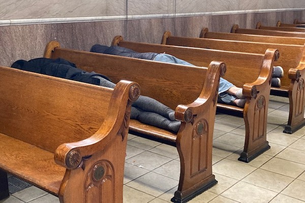 people sleeping on pews