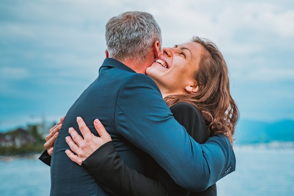 smiling woman hugging man