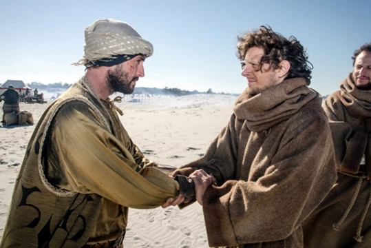 Sultan and St. Francis shake hands in the Egyptian desert.