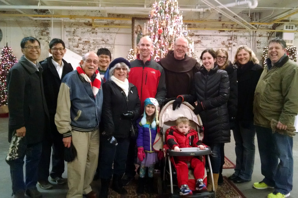 Br. Tim Sucher surrounded by families visiting the Franciscan Christmas at the Christian Moerlein Event Center