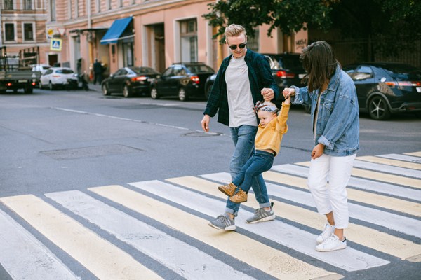 couple with child crossing street