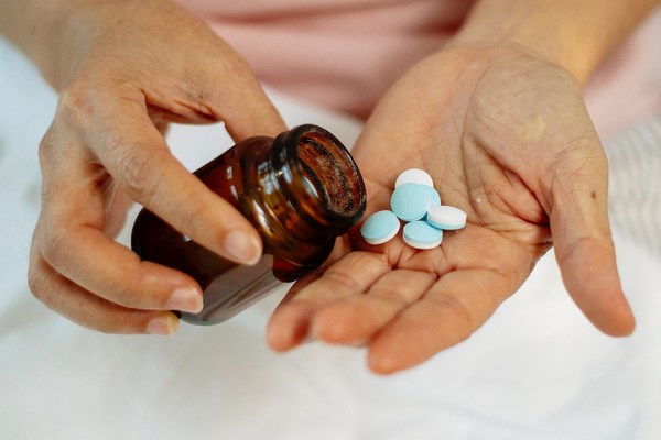 pills and bottle in hands